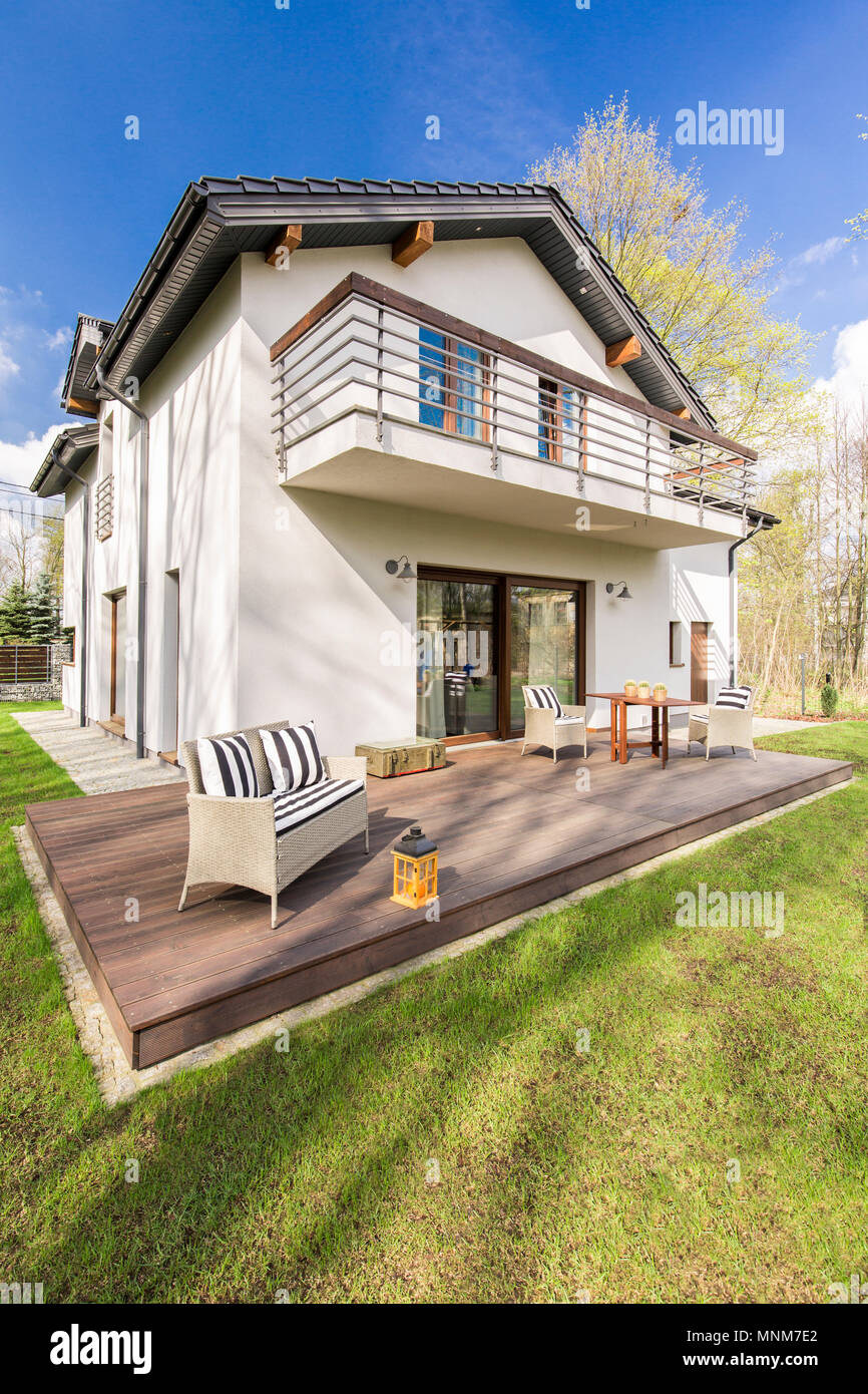 Shot of a big detached house with a tarrace in the backyard Stock Photo