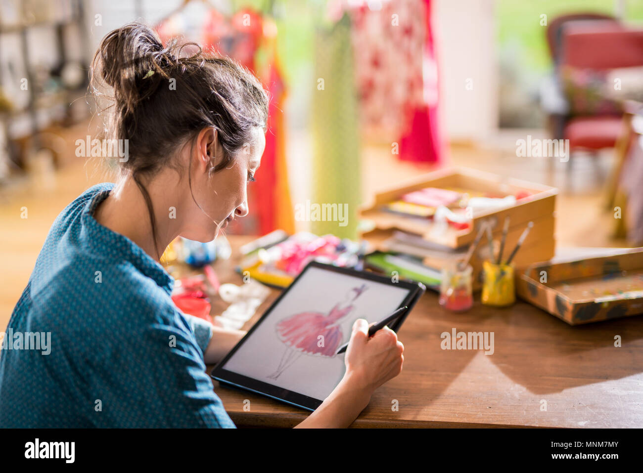 Fashion designer drawing a new model on a digital tablet Stock Photo