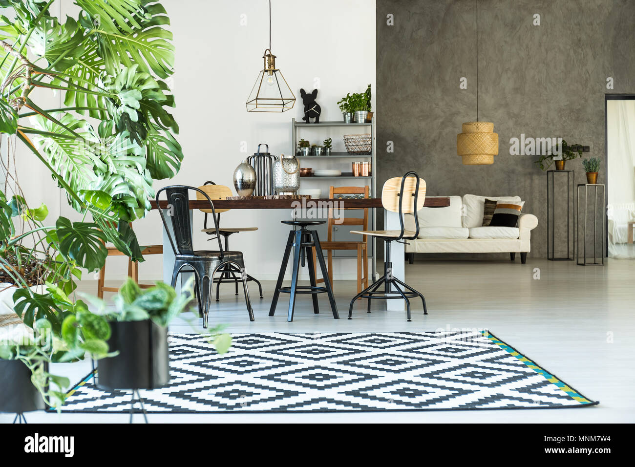 Modern interior with pattern carpet, table and chairs Stock Photo - Alamy