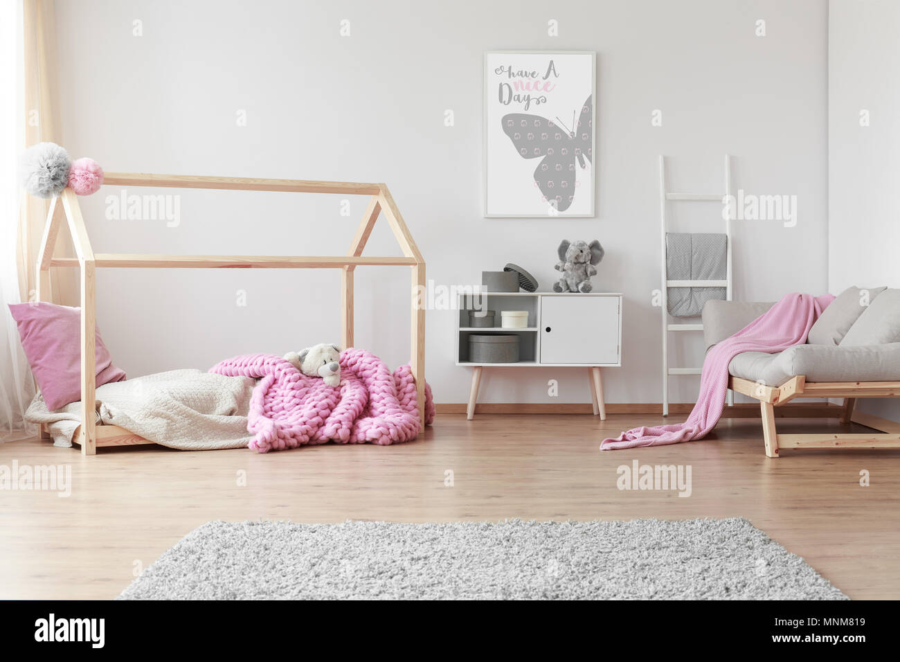 Cozy baby girl room with positive poster of a butterfly on the wall
