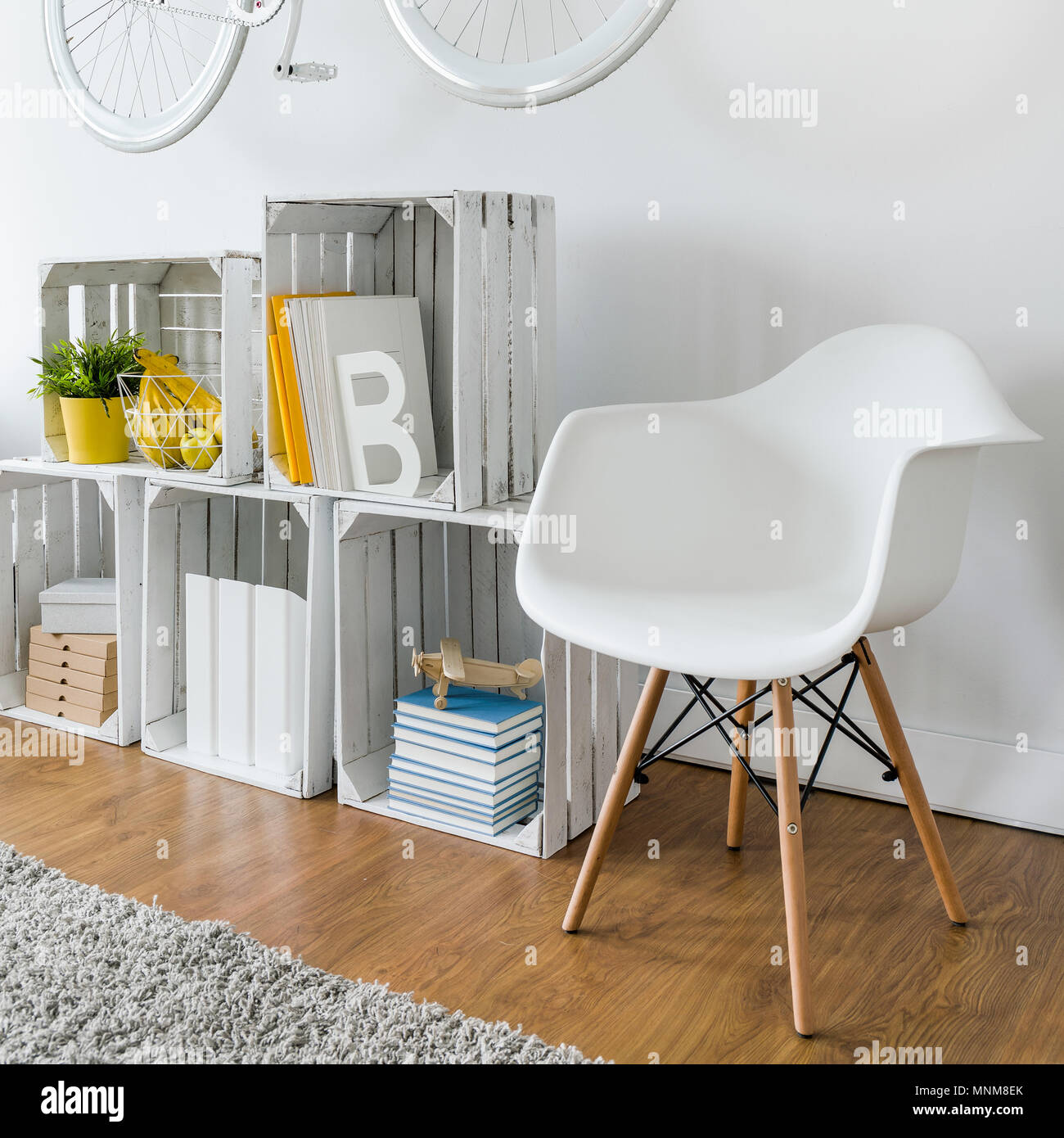 Shelf made from wood box, chair and bike hanging on white wall Stock ...