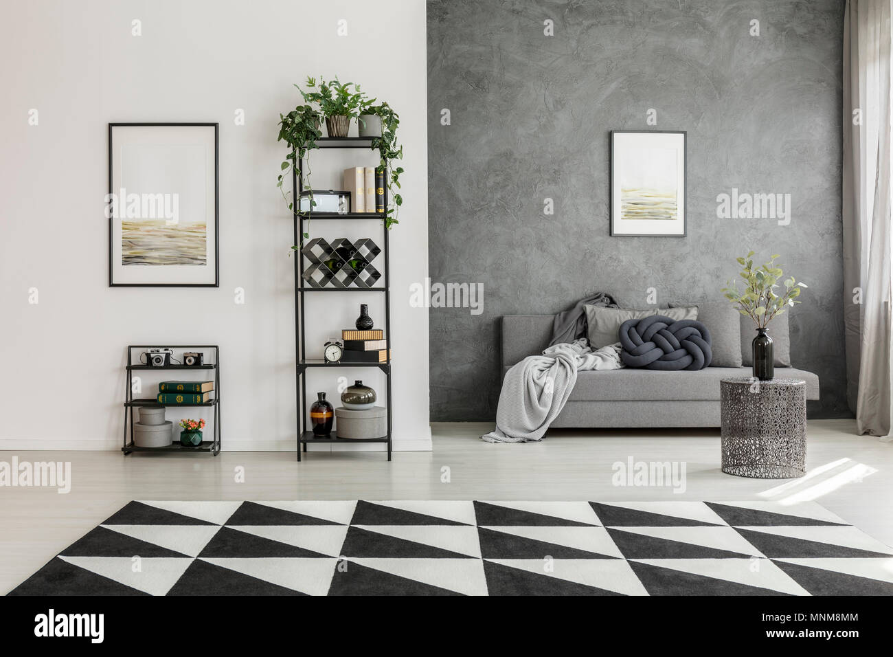 Geometric, black and white carpet in monochromatic living room interior