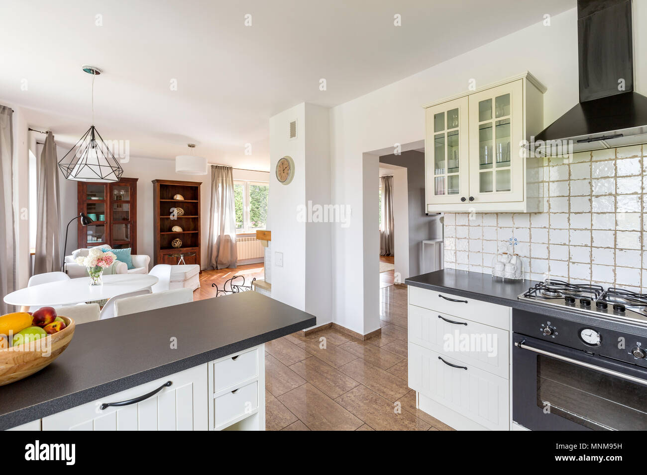 Small white kitchen open to a light dining area Stock Photo