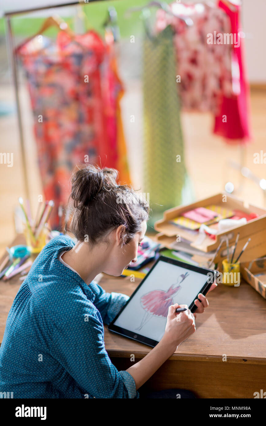 Fashion designer drawing a new model on a digital tablet Stock Photo