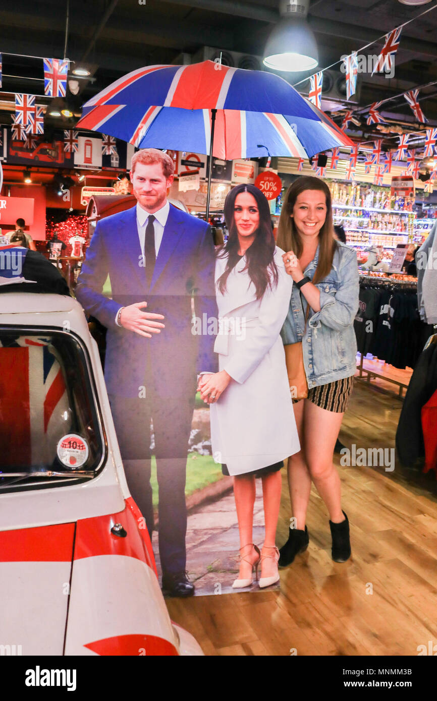 London UK. 18th May 2018. A happy fan poses next to cardboard cutouts  featuring Britain's Prince Harry and his fiance, US actress Meghan Markle are displayed in a Glorious Britain gift shop and provide a popular tourist attraction in Picaddily as the couple tie the knot on 19 May Credit: amer ghazzal/Alamy Live News Stock Photo