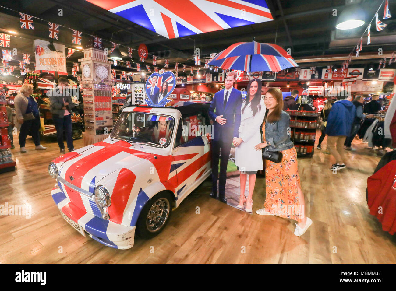 London UK. 18th May 2018. A fan poses next to cardboard cutouts  featuring Britain's Prince Harry and his fiance, US actress Meghan Markle are displayed in a Glorious Britain gift shop and provide a popular tourist attraction in Picaddily as the couple tie the knot on 19 May Credit: amer ghazzal/Alamy Live News Stock Photo
