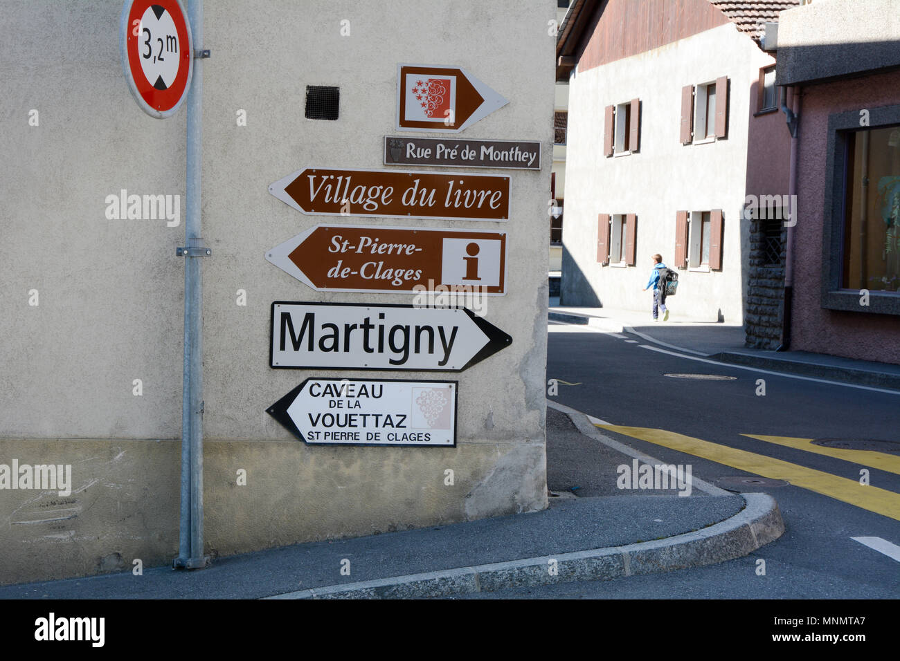 Signs on a street corner in the village of St.-Pierre-de-Clages in the Upper Rhone Valley region, Valais canton, southern Switzerland. Stock Photo