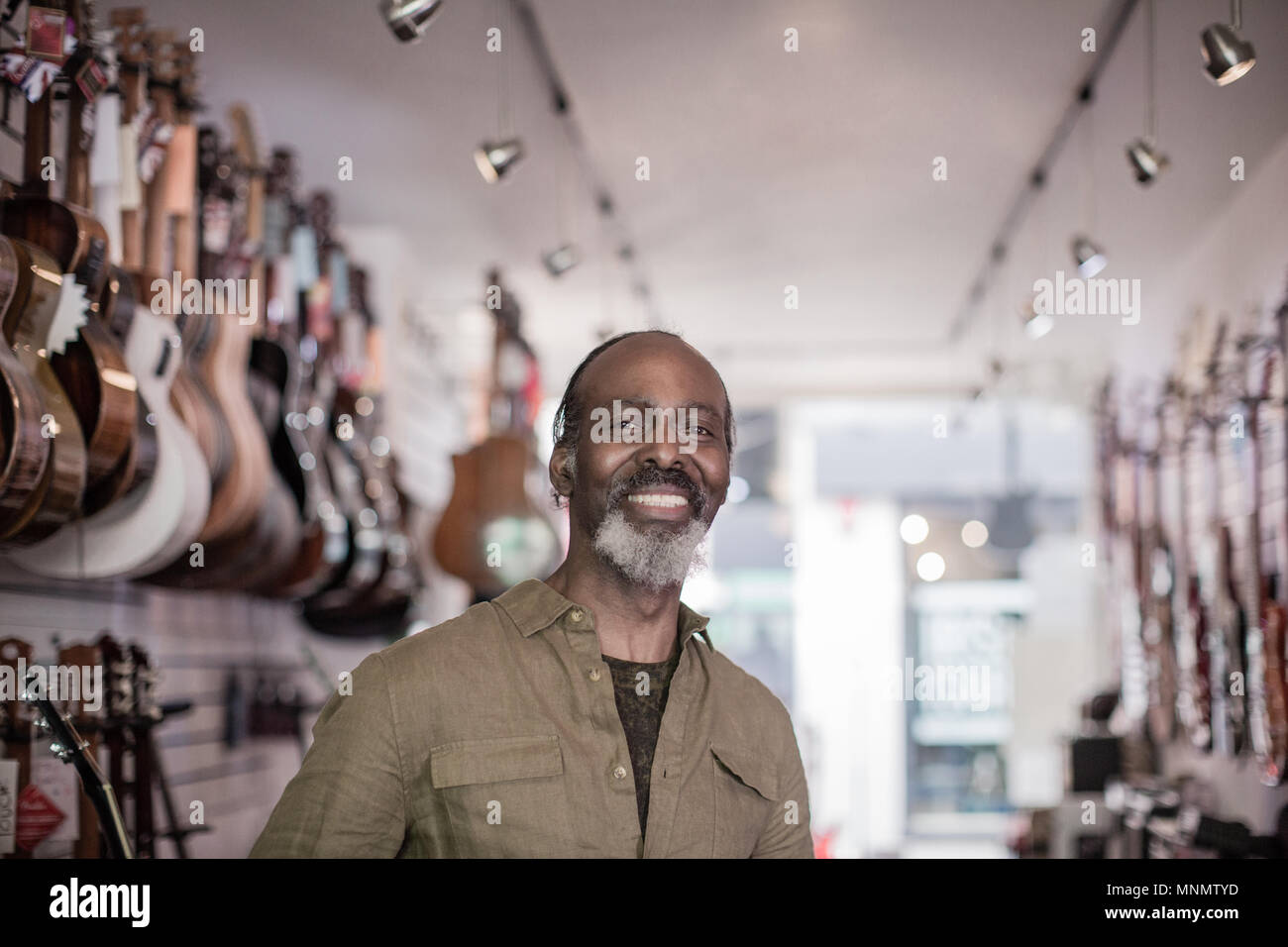 Portrait of a small business owner in a guitar store Stock Photo