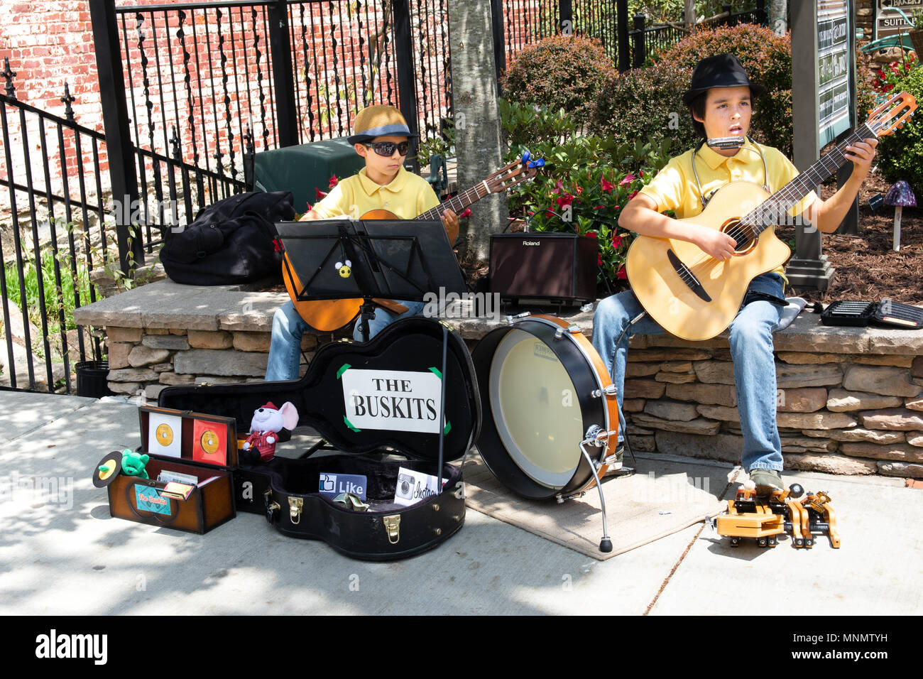 Two young boys busking with guitars on Main street in Blowing Rock, NC, USA. Stock Photo