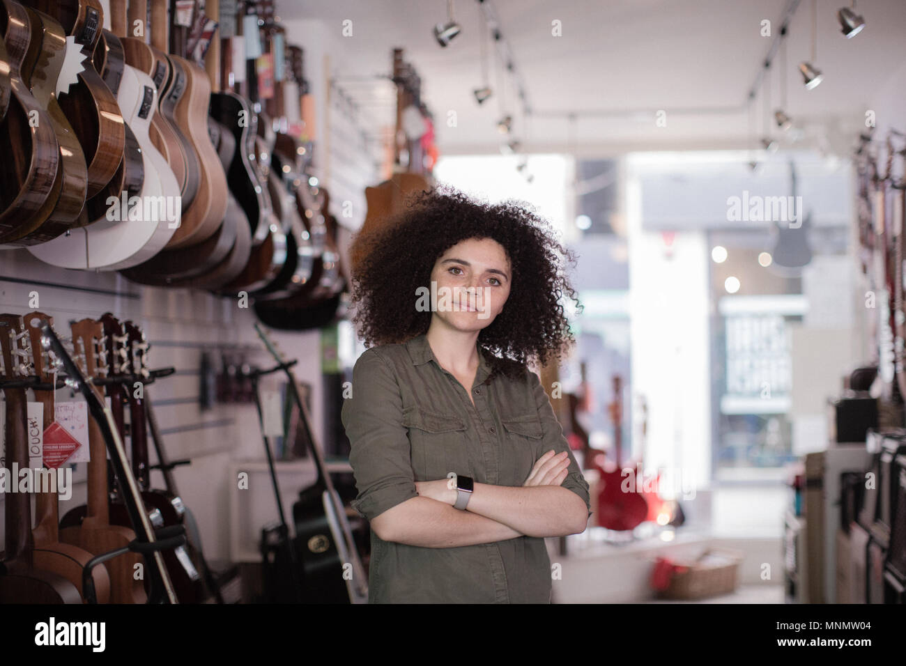 Portrait of a small business owner in a guitar store Stock Photo