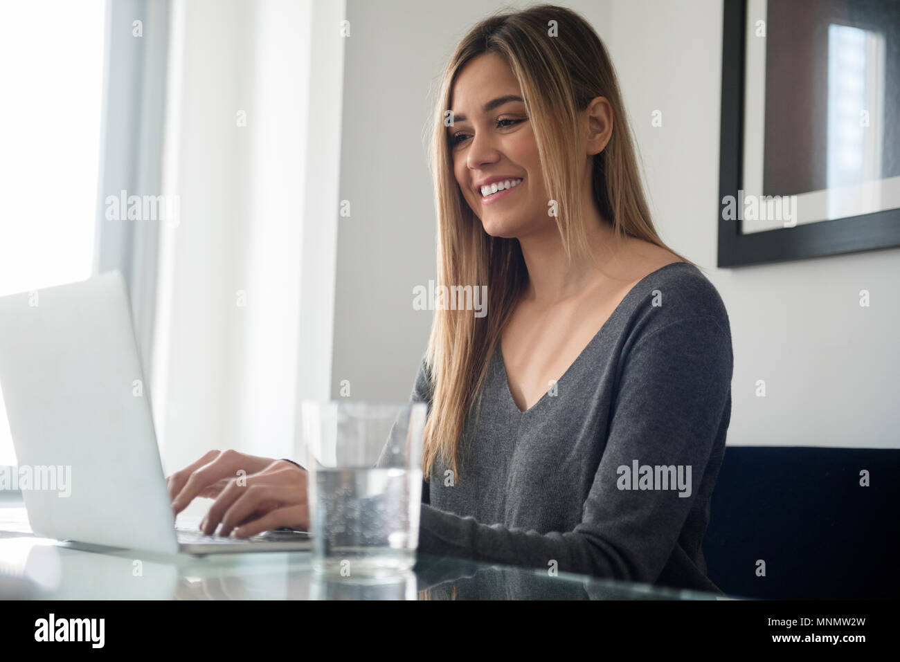Young woman using laptop Stock Photo