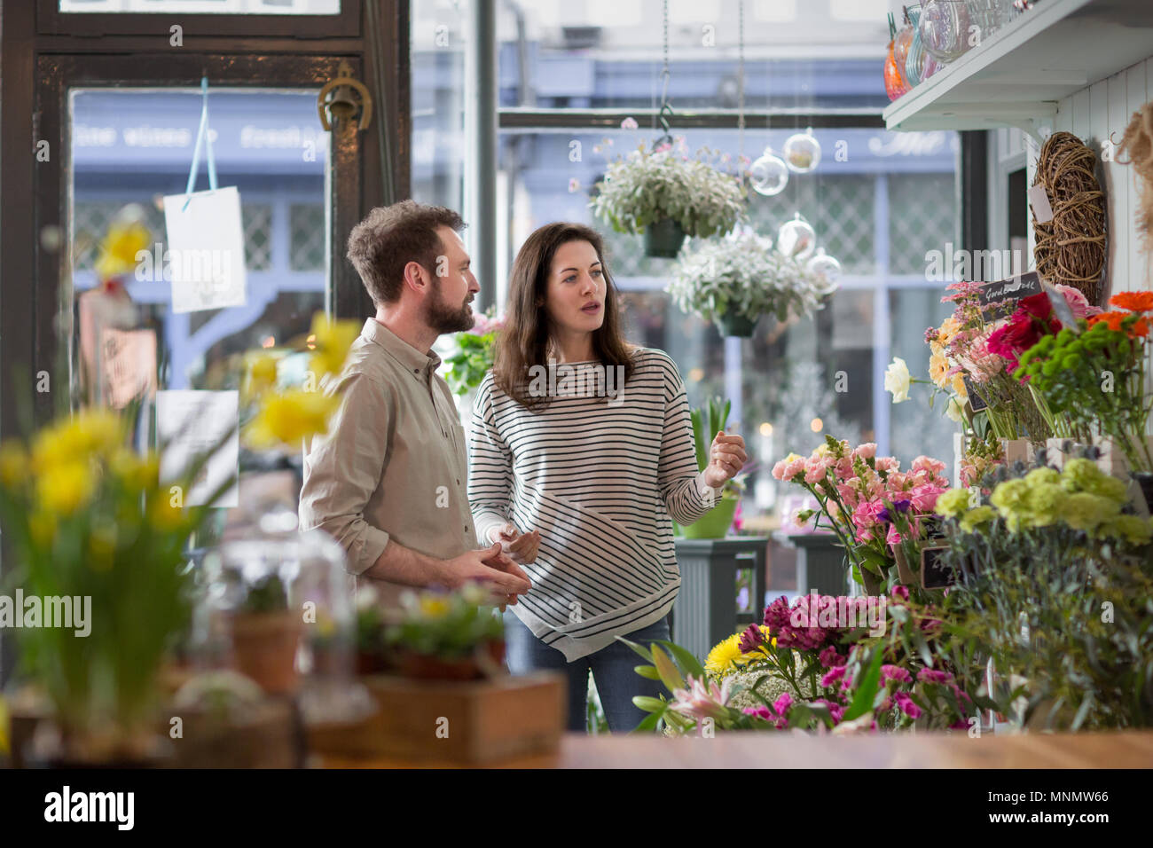 Florist serving customer in a store Stock Photo