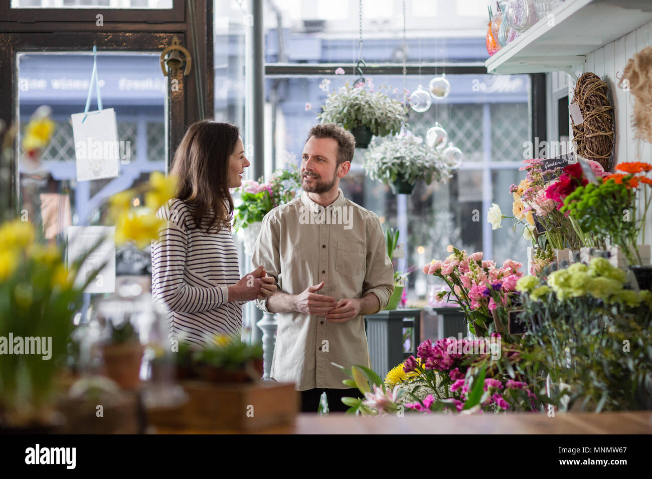 Florist serving customer in a store Stock Photo