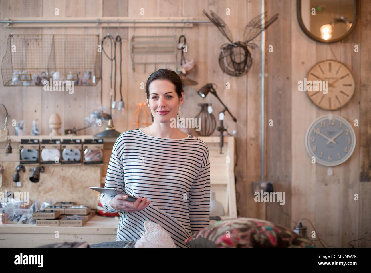 Portrait of small business owner holding digital tablet in a home store Stock Photo