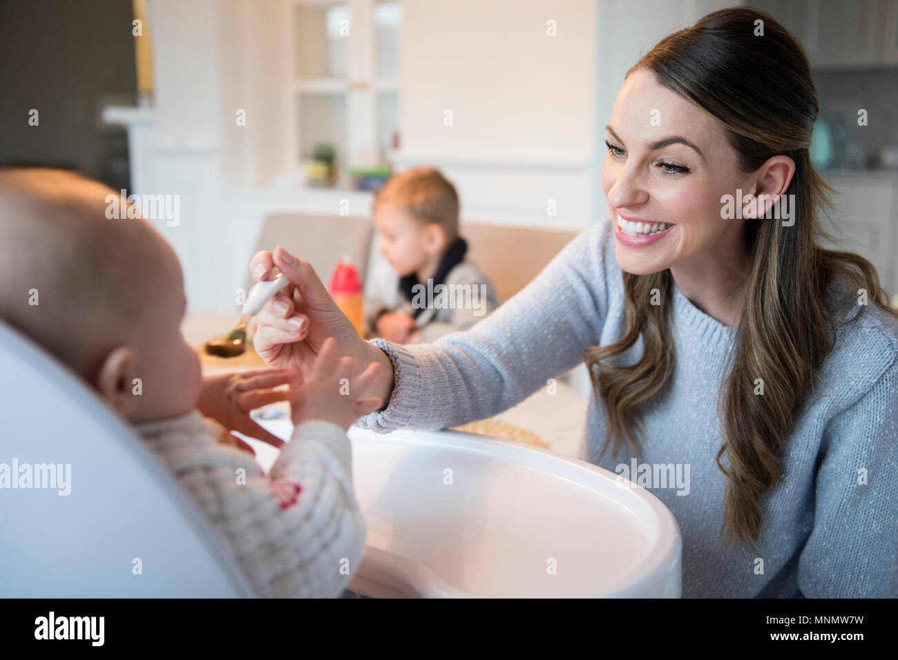 Mother feeding baby (18-23 months) Stock Photo