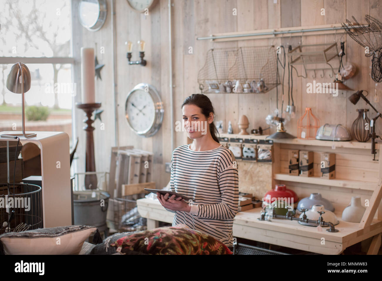 Portrait of small business owner holding digital tablet in a home store Stock Photo