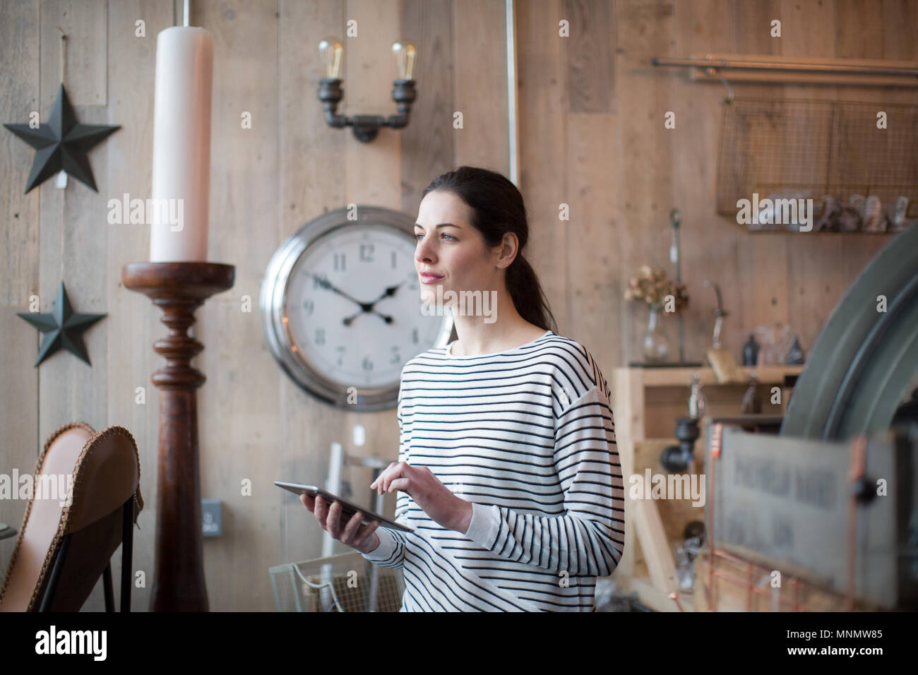 Small business owner using digital tablet in a store Stock Photo