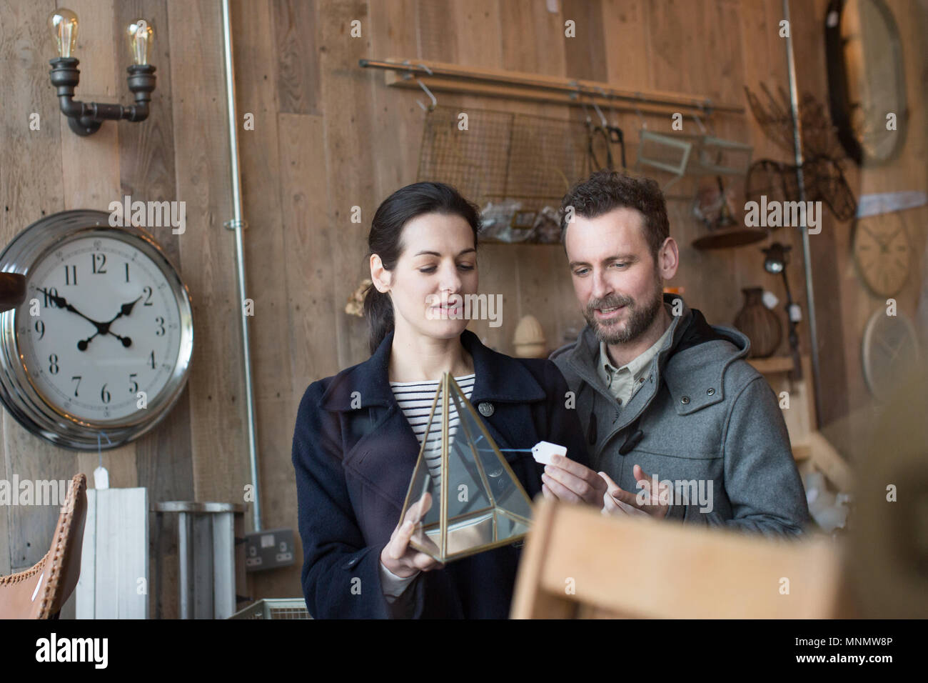 Couple looking at price tag in a home store Stock Photo