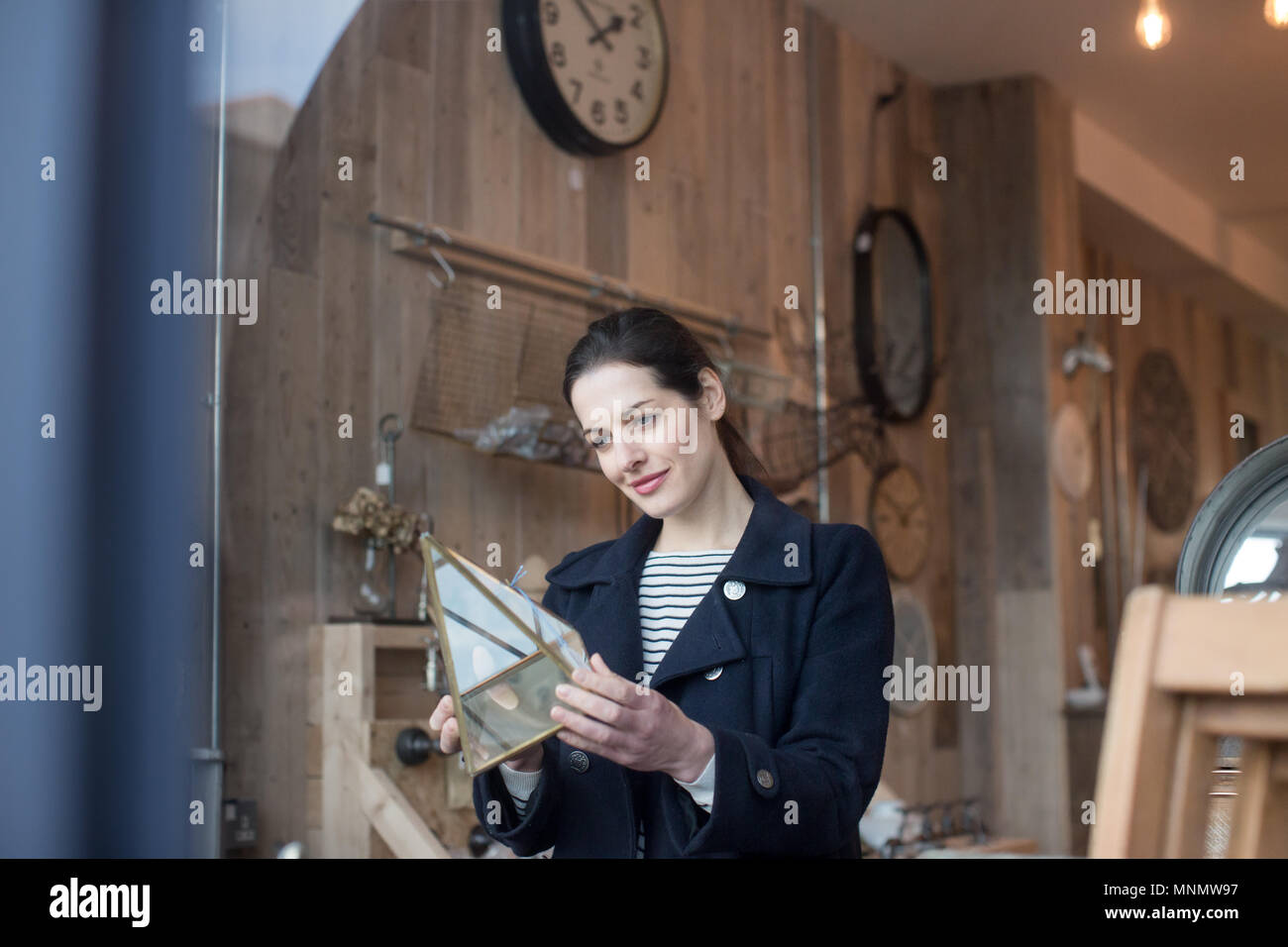 Adult female shopping in a vintage antique store Stock Photo