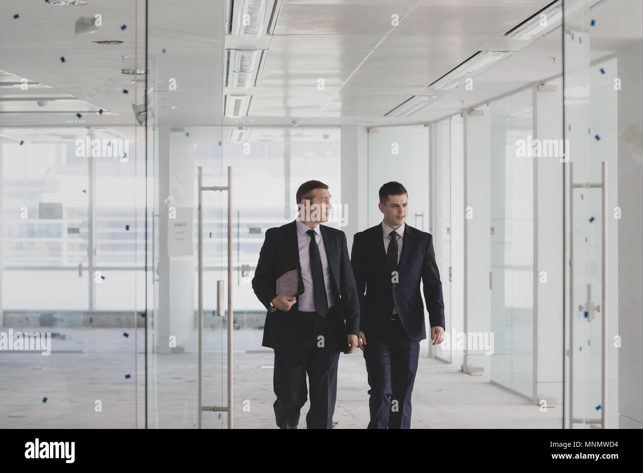 Businessmen looking at new office space Stock Photo