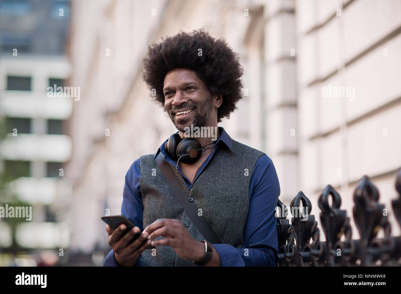 African American male using smartphone outdoors Stock Photo