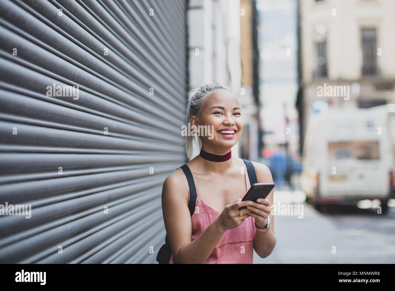 Young adult female messaging on smarphone Stock Photo