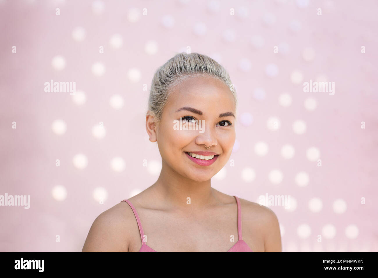 Young adult female with pink background Stock Photo