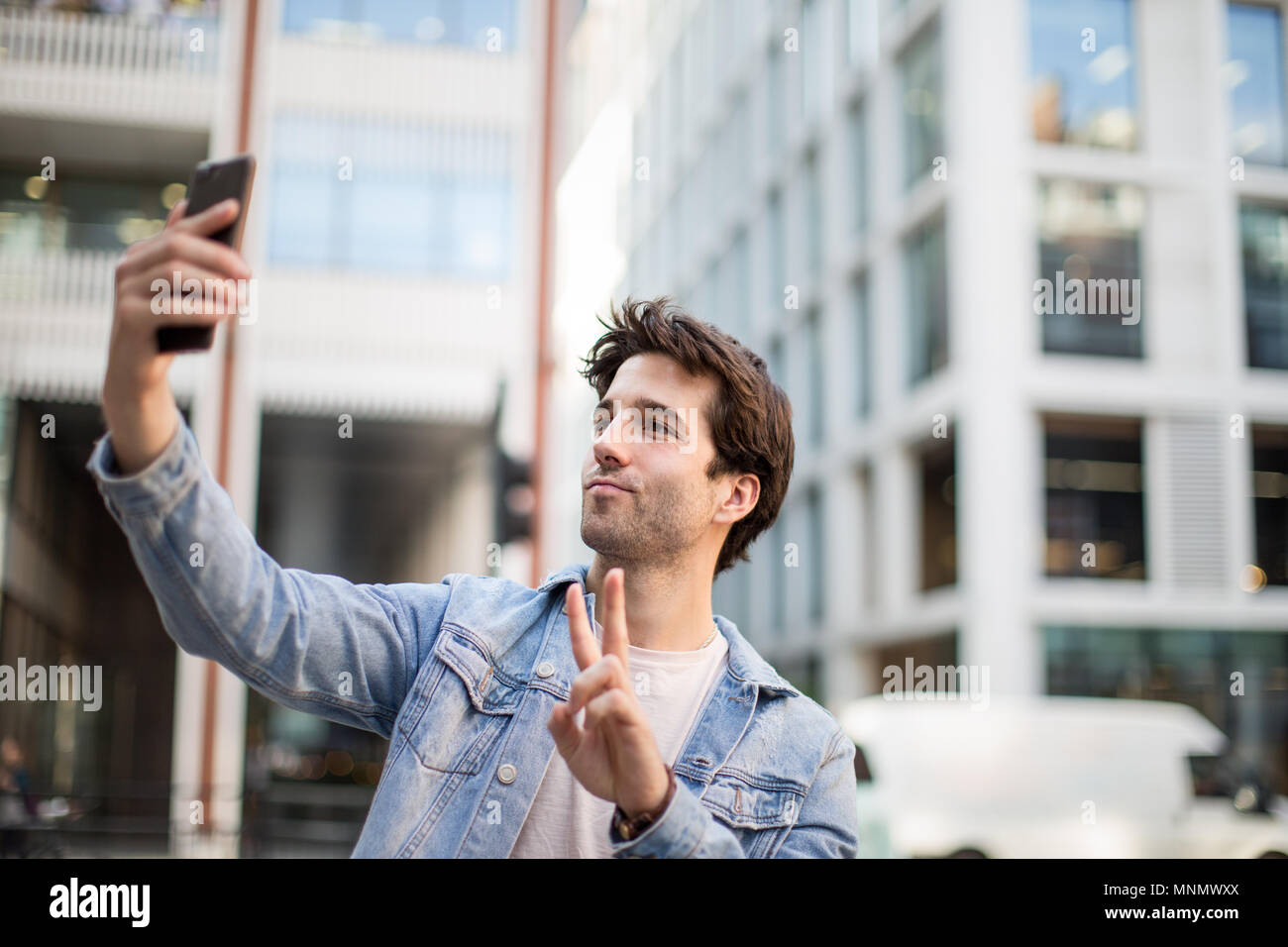 Young adult male tourist posing for selfie Stock Photo