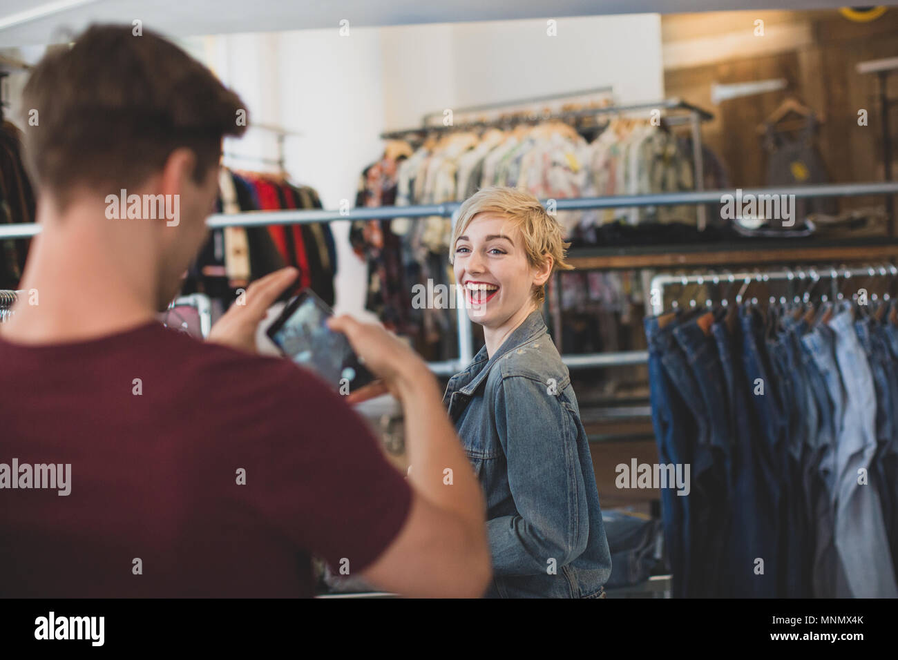 Millennial couple in a vintage clothing store Stock Photo