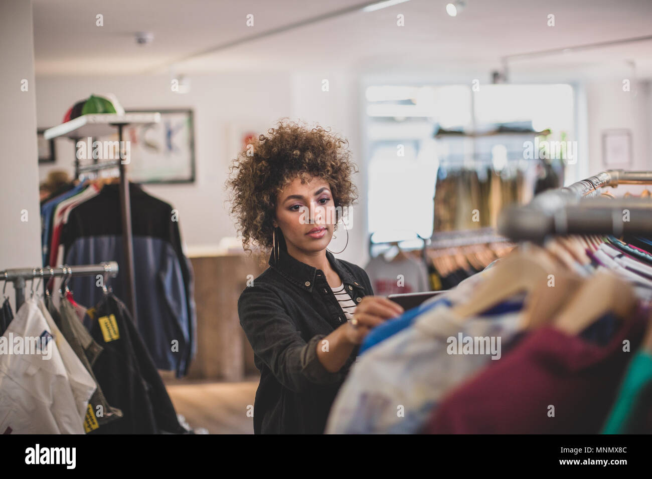 Store manager checking stock in a clothing store Stock Photo