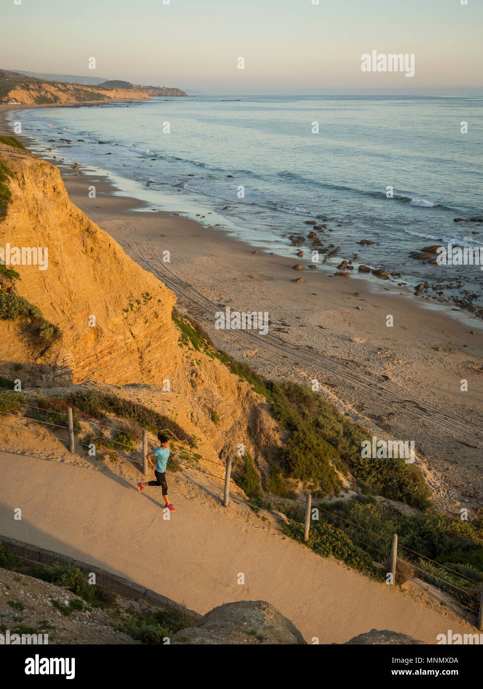 USA, California, Newport Beach, Woman running along footpath Stock Photo