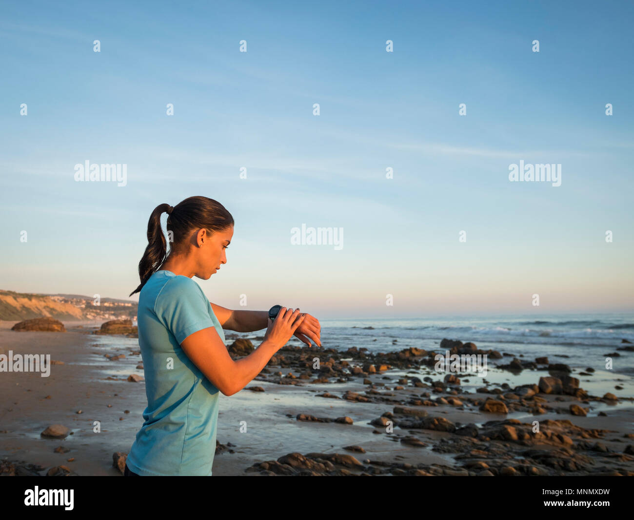 USA, California, Newport Beach, Woman checking smart watch Stock Photo