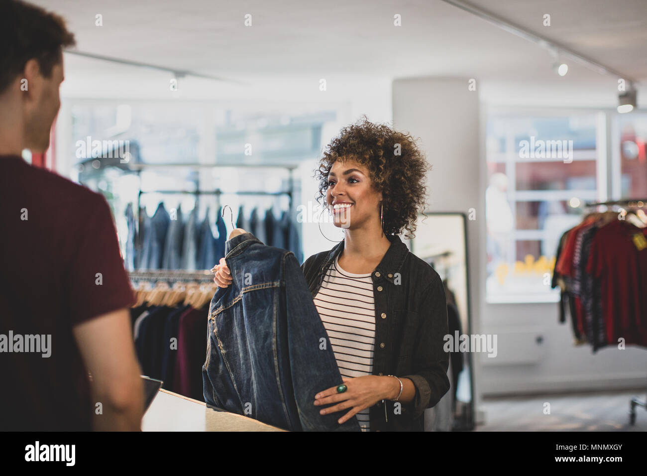 Customer paying for clothes at checkout Stock Photo