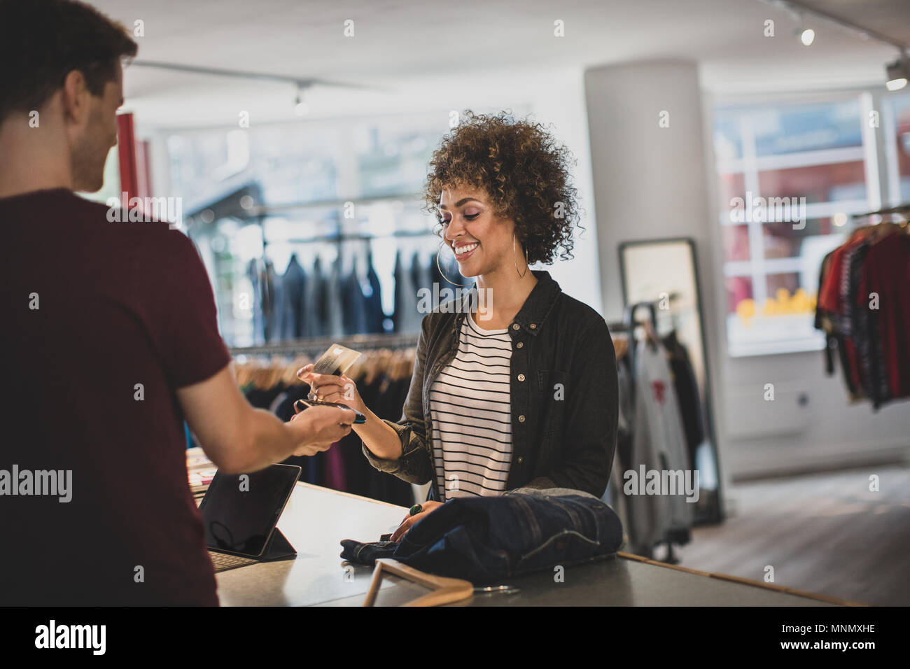 Customer paying for clothes at checkout Stock Photo