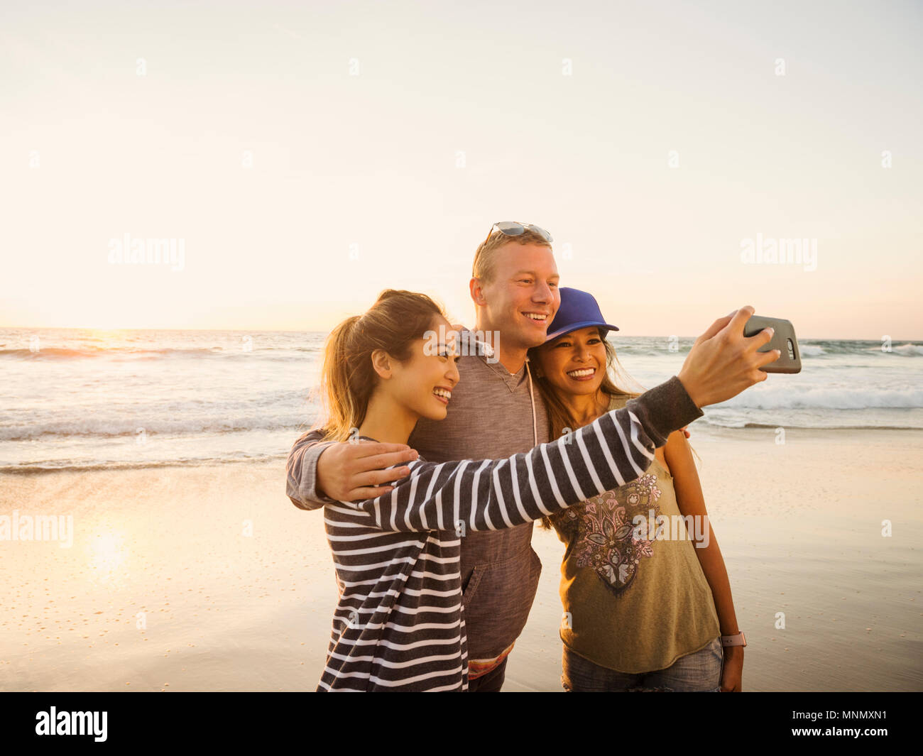 Family taking selfie on beach Stock Photo