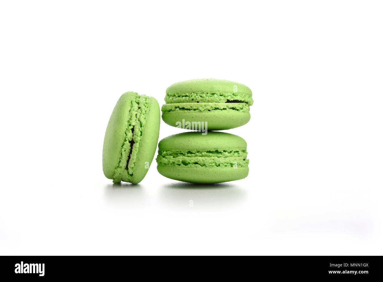 Three green macaroons isolated on white background Stock Photo