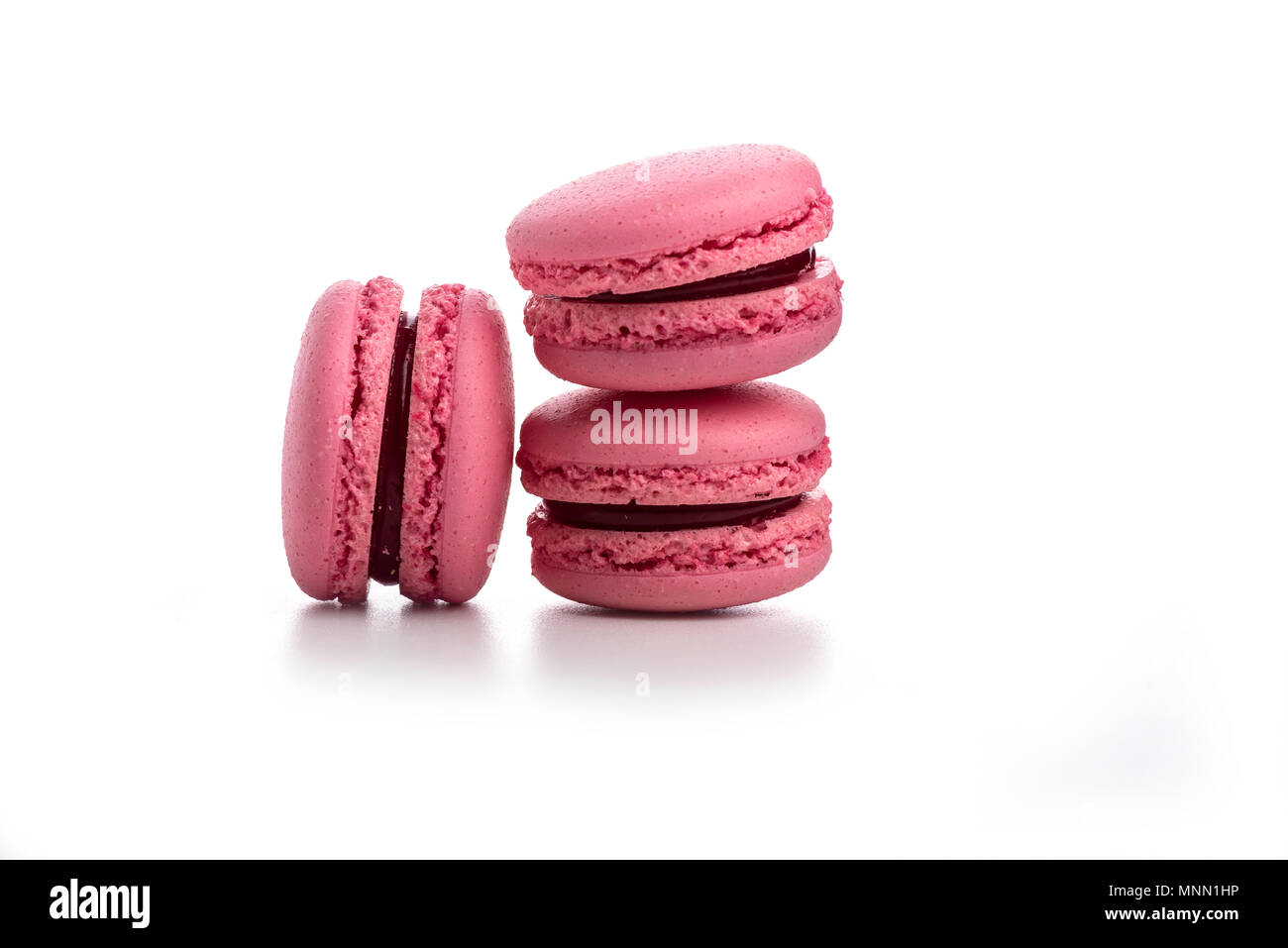 Three pink macaroons isolated on white background Stock Photo