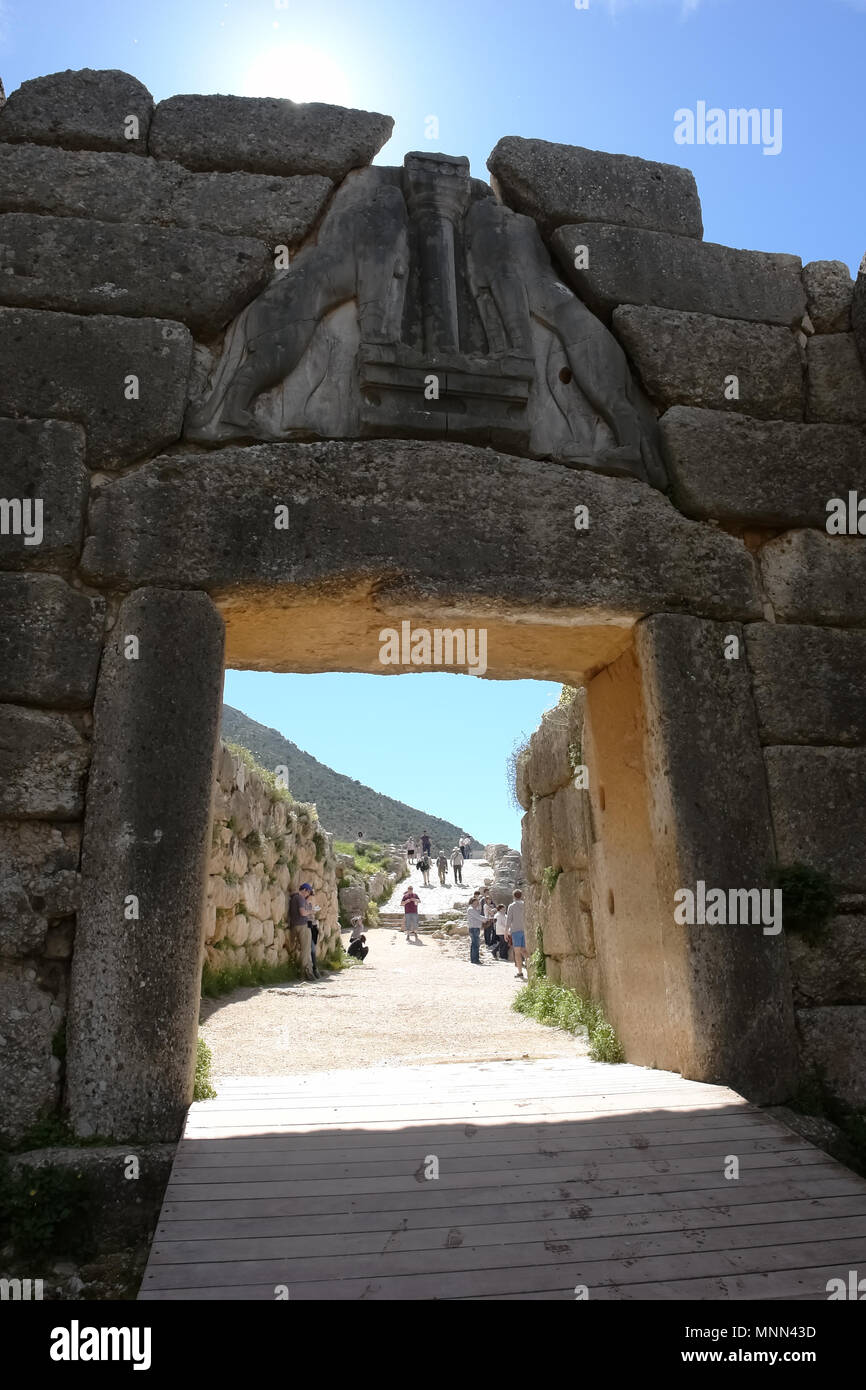 Mykines, Greece - April 1, 2015: View through the Lion Gate on a stone path and tourists in the ancient acropolis in Mycenae. Stock Photo