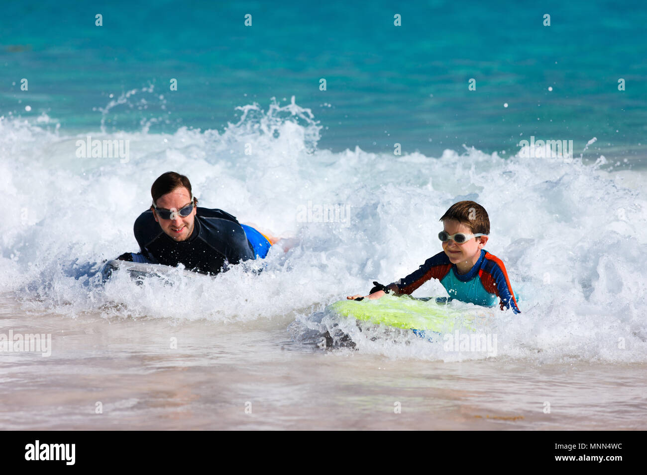 Father and son surfing on boogie boards Stock Photo Alamy
