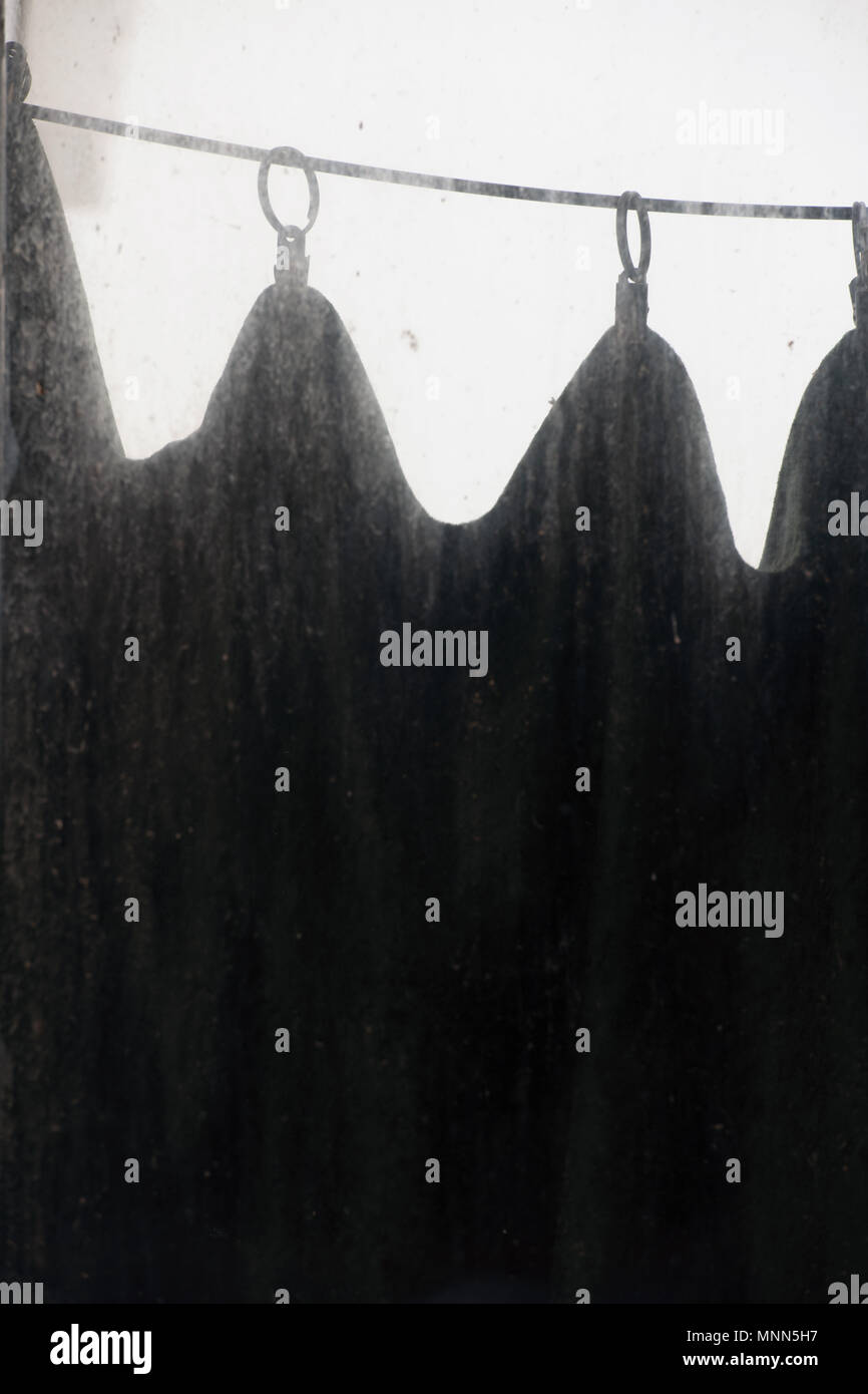Black Curtain Sag On The Rings Behind The Dirty Dust Stained
