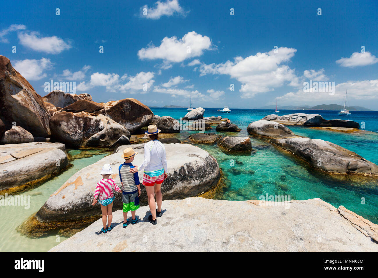 Family of mother and kids at The Baths beach area major tourist