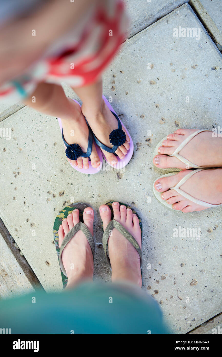 Top view of family mother and kids feet in flip flops on summer vacation  Stock Photo - Alamy