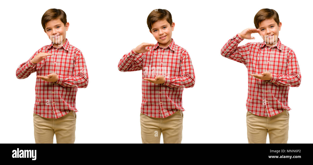 Handsome toddler child with green eyes holding something, size concept Stock Photo