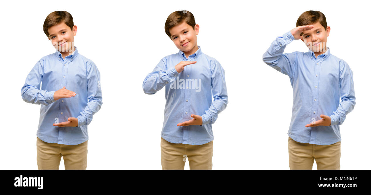 Handsome toddler child with green eyes holding something, size concept Stock Photo