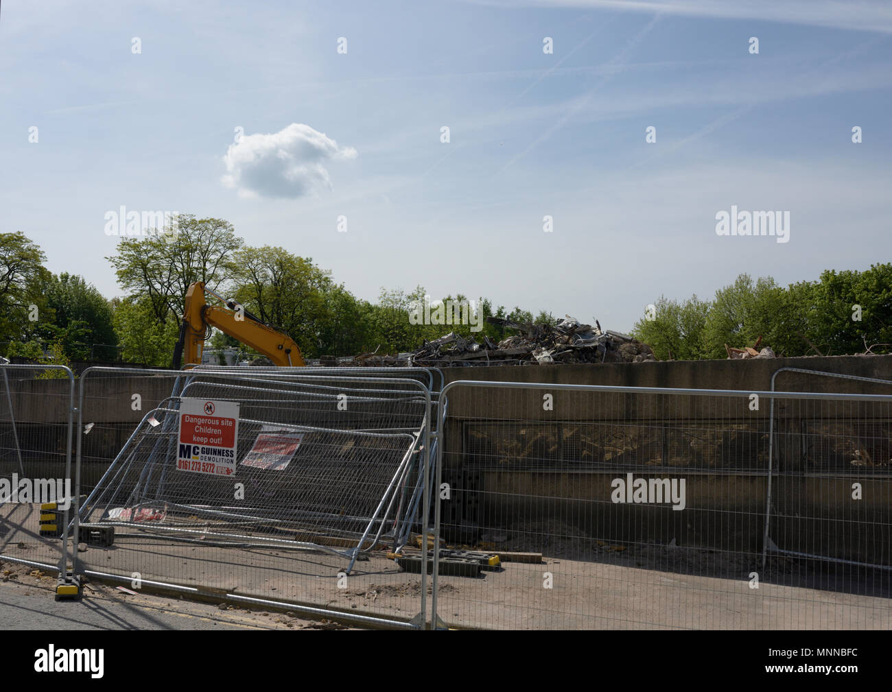 Steel security fencing with warning sign in front of demolition site, former police headquarters