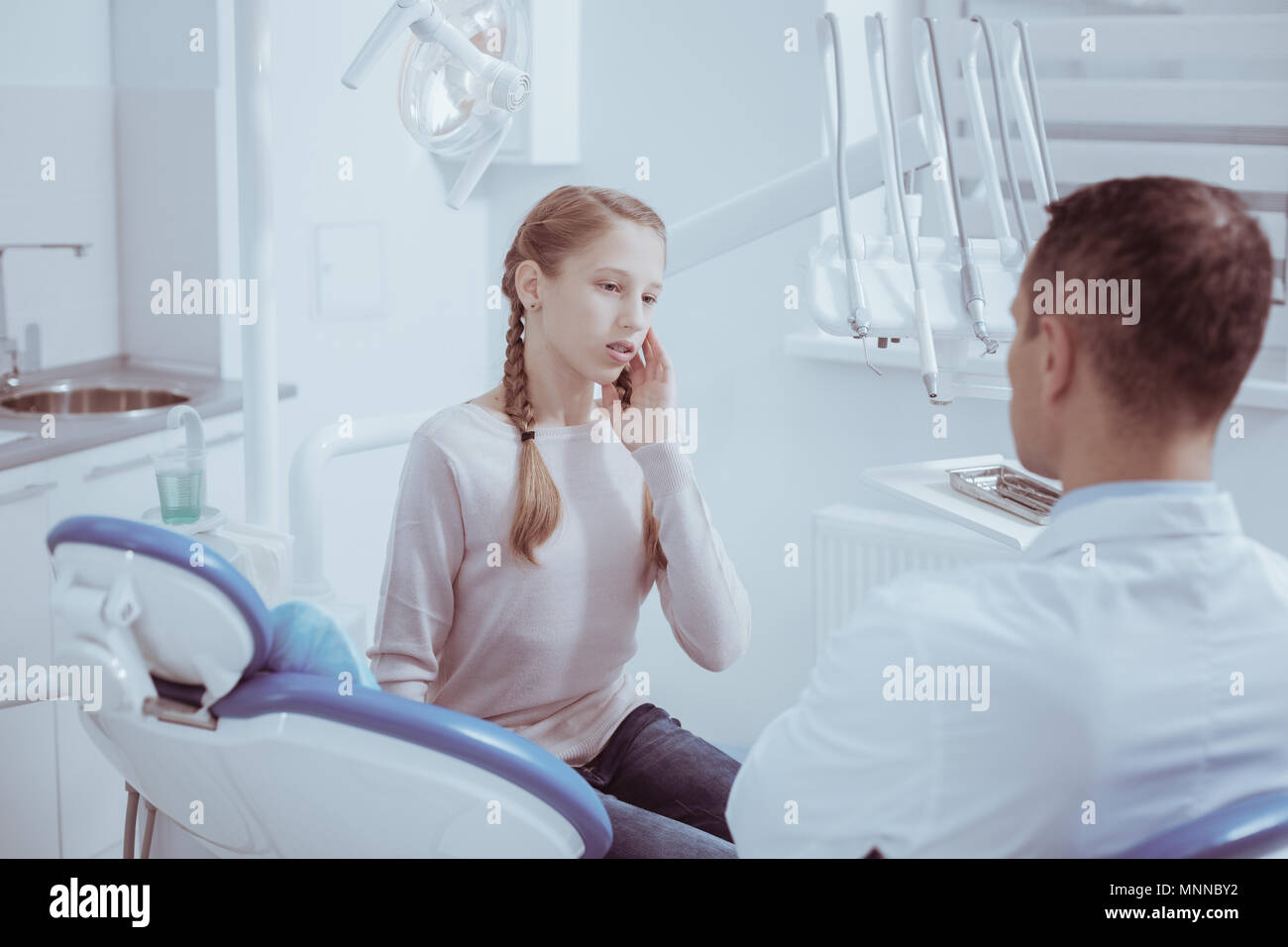Dismal pleasant girl explaining pain in teeth stock photo alamy
