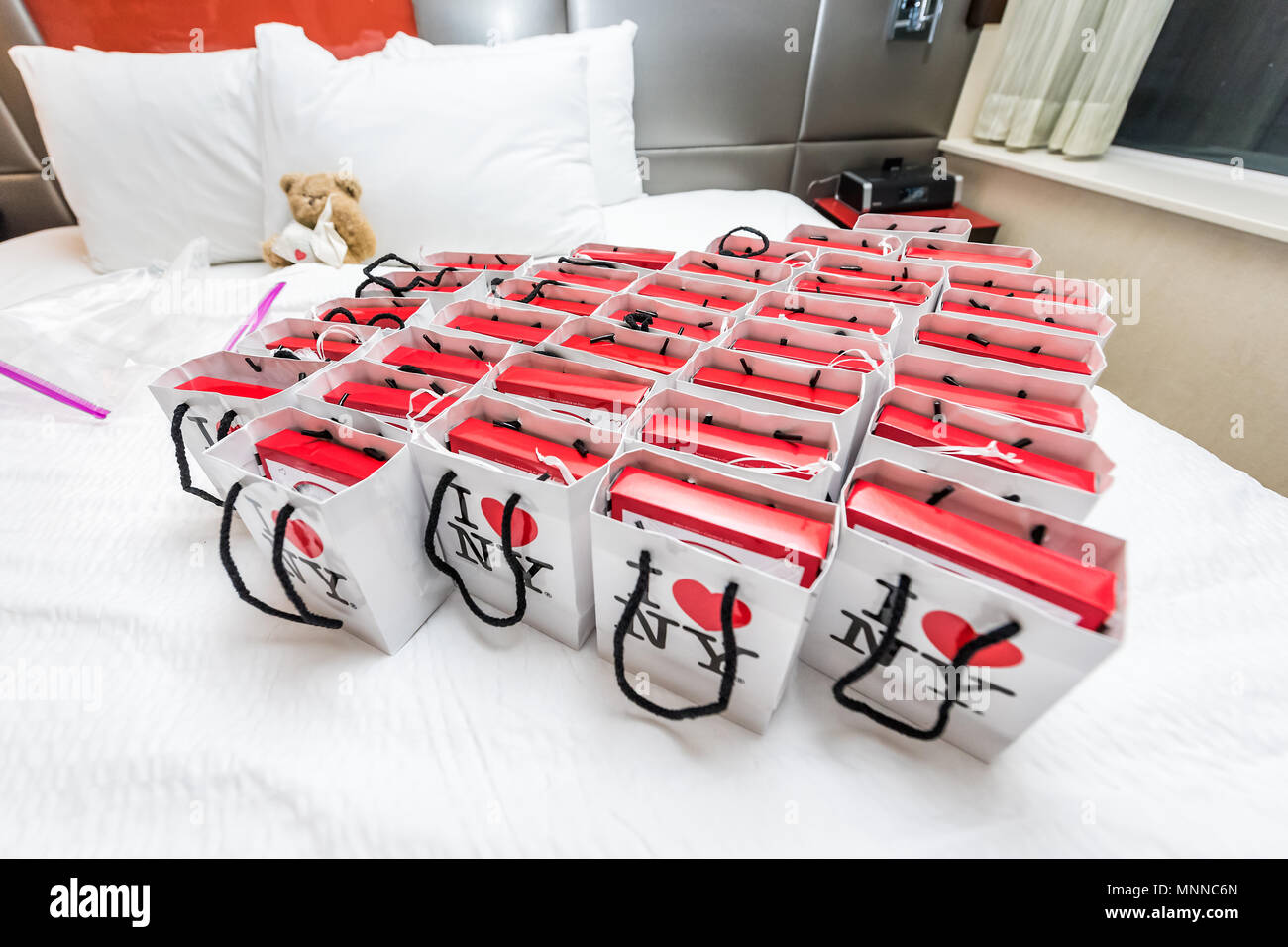 New York City, USA - April 6, 2018: Many I heart love NY NYC gift bags on hotel room bed as wedding favors closeup Stock Photo