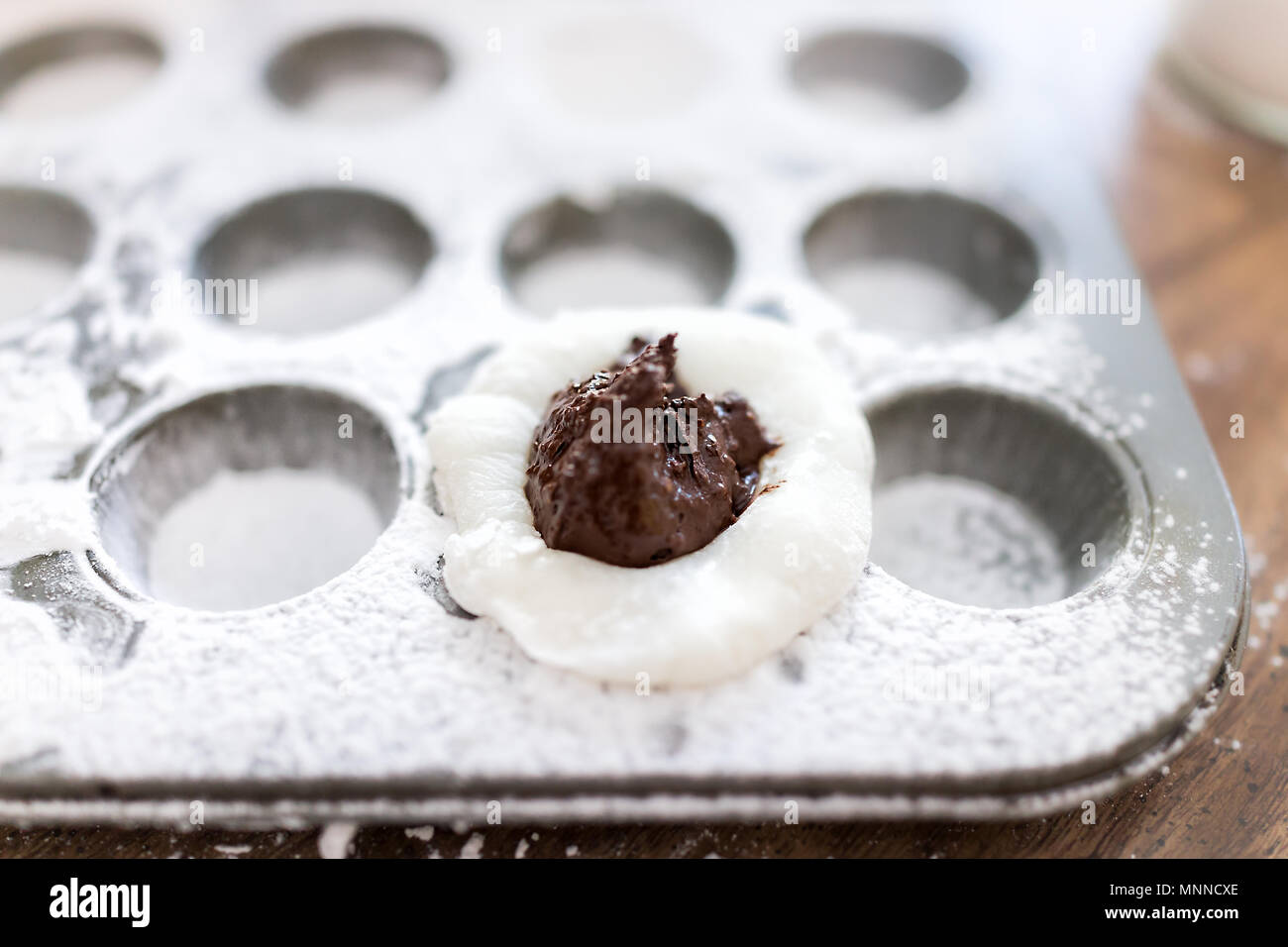 Piece of mochi sticky glutinous rice cake dusted with starch flour to