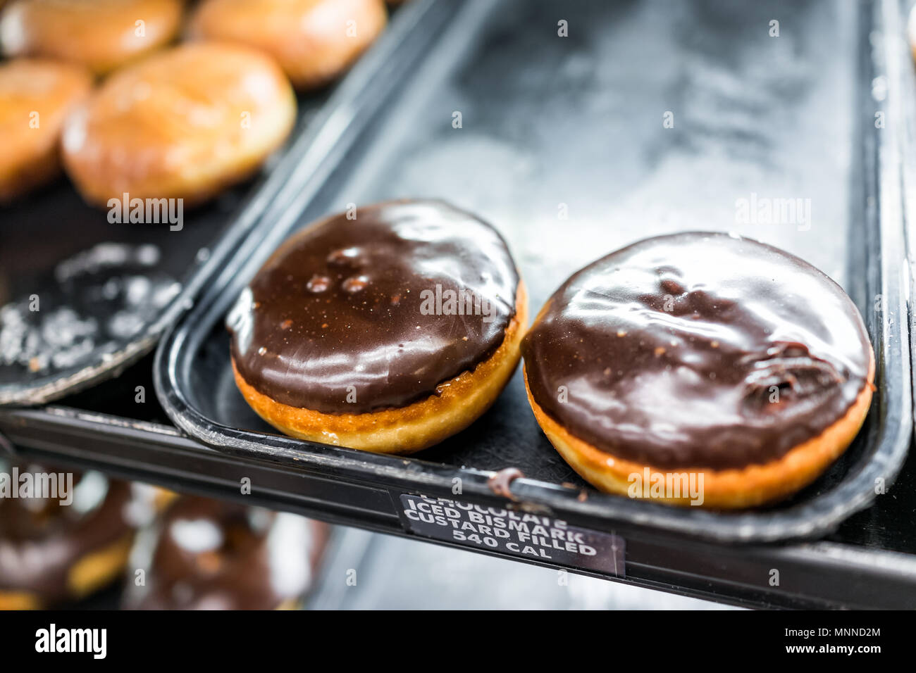 Chocolate icing donuts with bismark custard filling sign closeup on