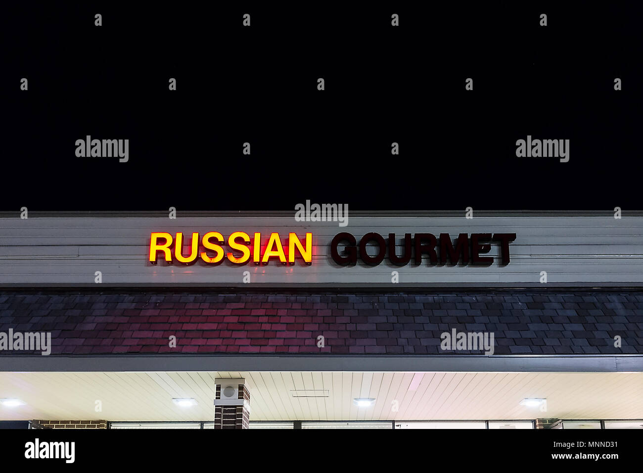Herndon, USA - March 8, 2018: Russian Gourmet eastern european goods food specialty store with produce and restaurant in Virginia at night with sign Stock Photo